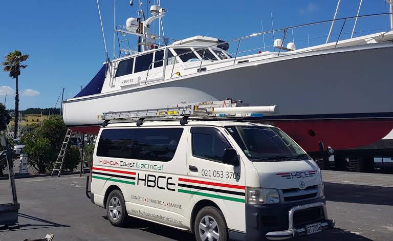 Hibiscus Coast Electrical van next to yacht